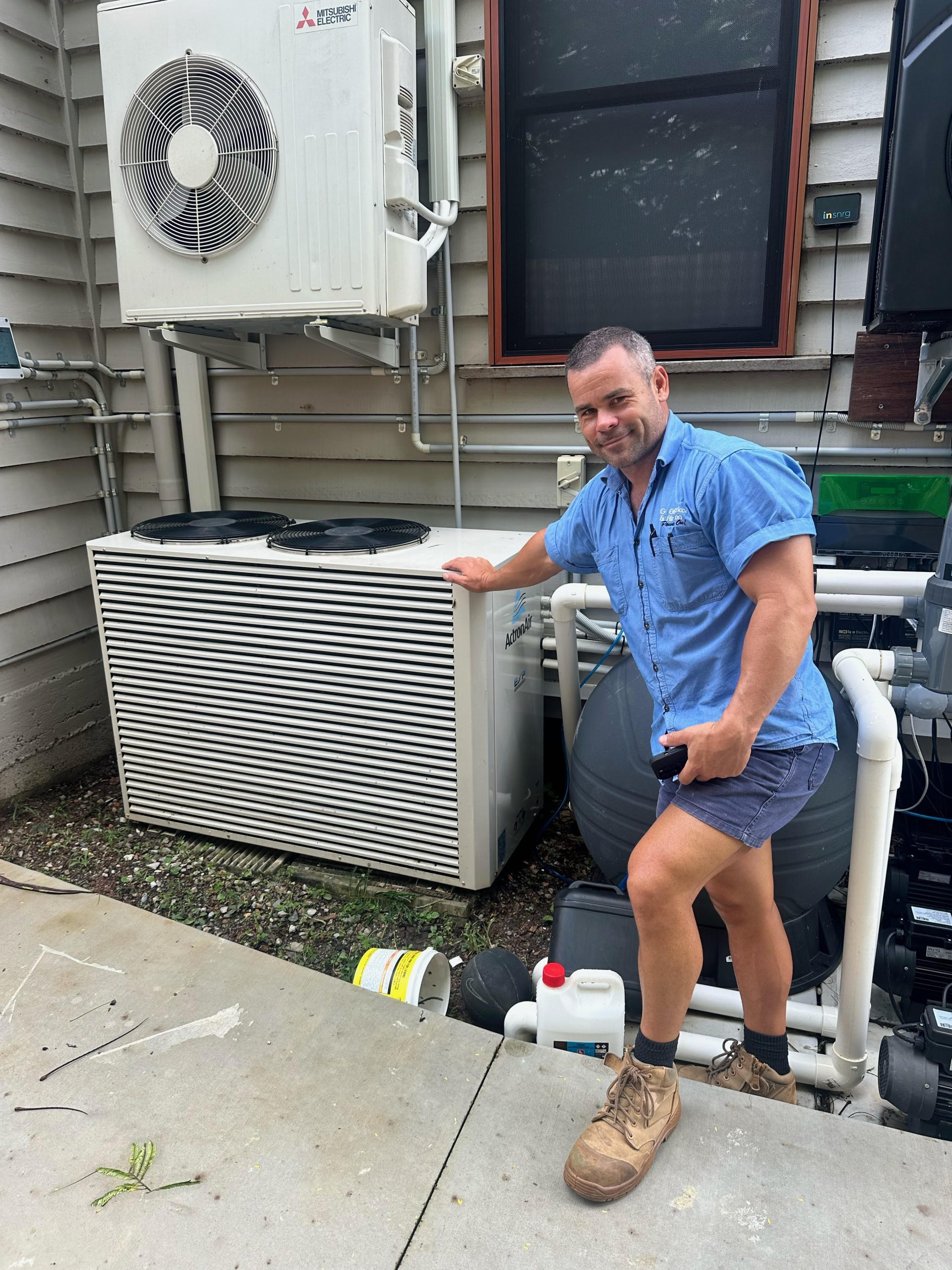 Brad next to outdoor air conditioning unit