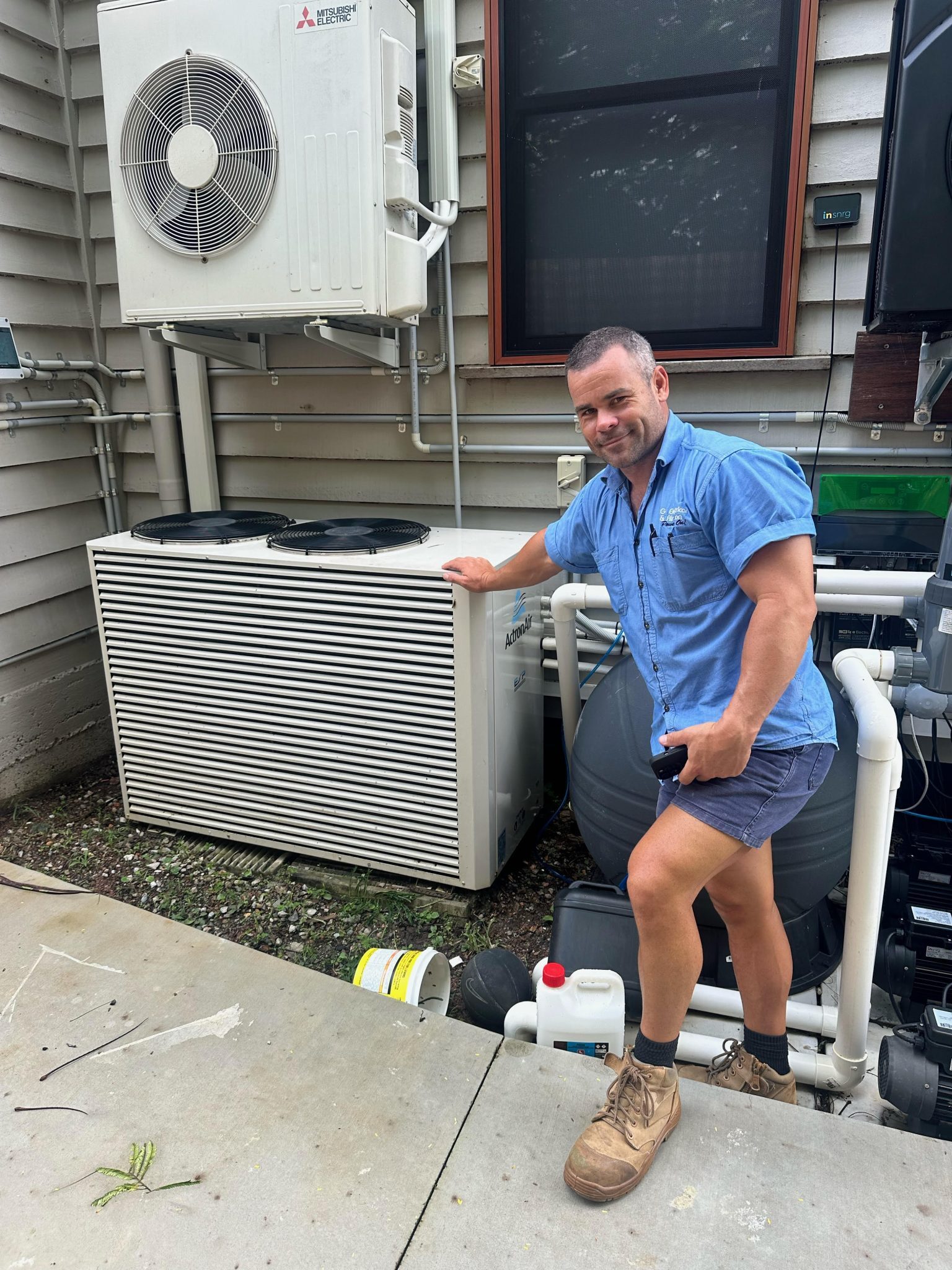Brad next to outdoor air conditioning unit