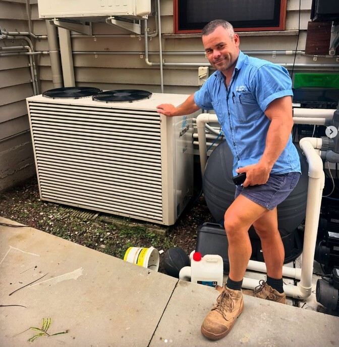 Brad next to AC unit outdoors